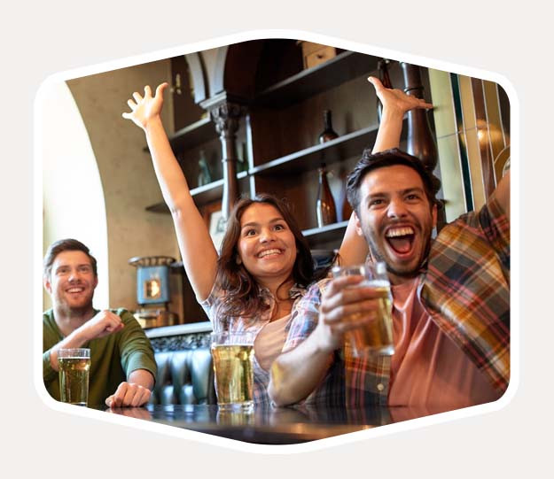 cheering-at-bar-grey-back People cheering in a pub