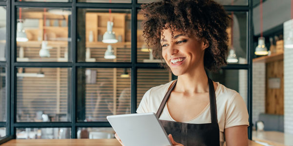 restaurants Smiling woman holding a tablet representing a restaurant owner